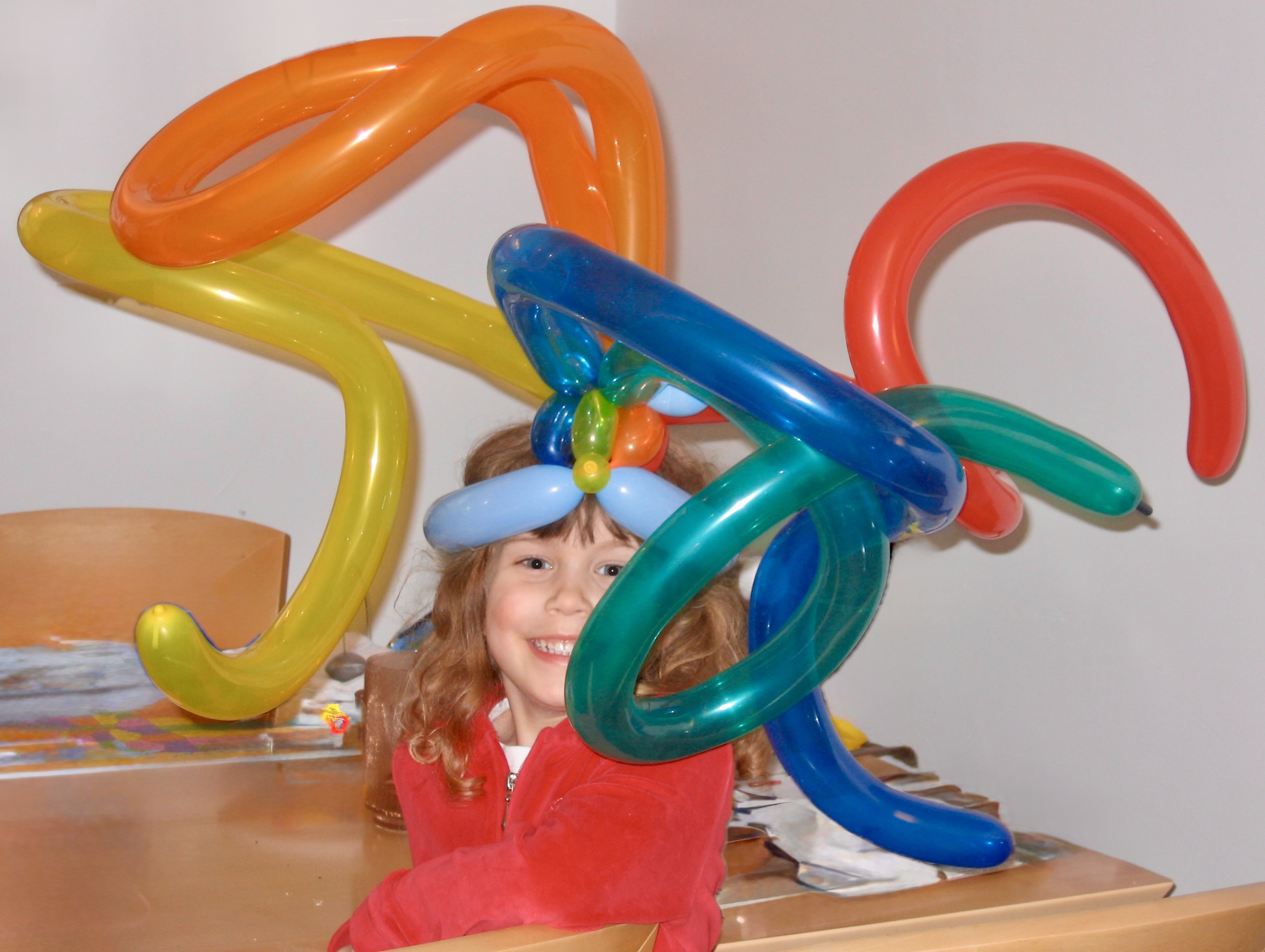 Child wearing balloon hat