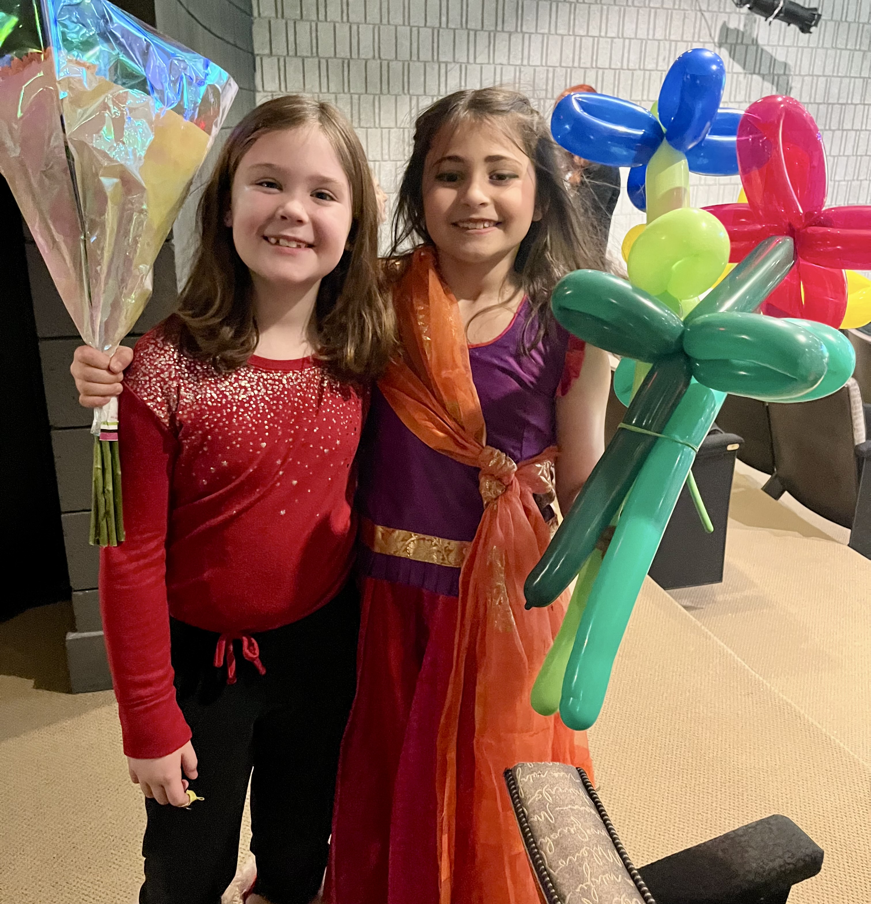 Smiling kids with balloon creations